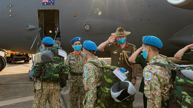 Australian Defence Attache to Vietnam Colonel Paul Foura and senior Vietnamese officers farewell Vietnamese Level Two Field Hospital personnel as they board an Air Force C-17A Globemaster III in Ho Chi Minh City. Photo: Cần Thơ Kỷ Yếu