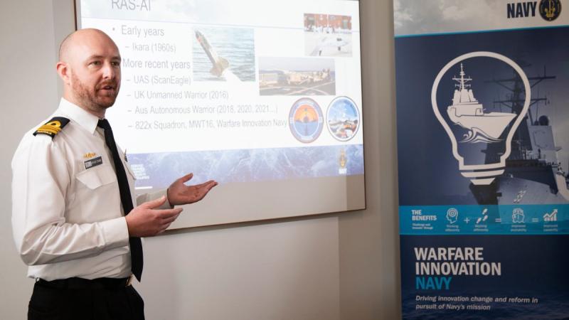 Lieutenant Commander Bryan Cromie from the Robotic Autonomous Systems and Artificial Intelligence Team, Warfare Innovation Navy, with a remotely piloted aircraft at the virtual Autonomous Warrior event.