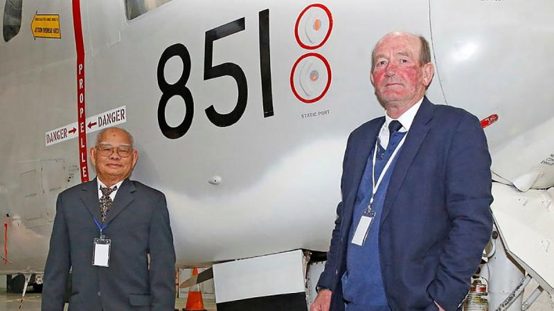 Skipper of refugee boat Nghia Hung, Tam Van Nguyen, with Royal Australian Navy Reserve Captain Chris Frost in front of Grumman Tracker 851 at the HARS Aviation Museum, Albion Park, NSW. Photo: Sergeant Dave Morley