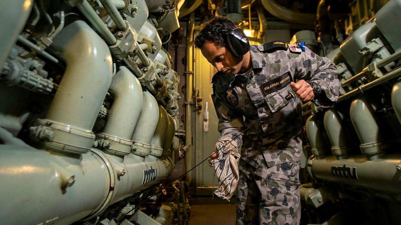 Able Seaman Avin Kulathum Meethal checks engine oil levels in the machinery space on board HMAS Ballarat during a Regional Presence Deployment. Photo: Leading Seaman Ernesto Sanchez