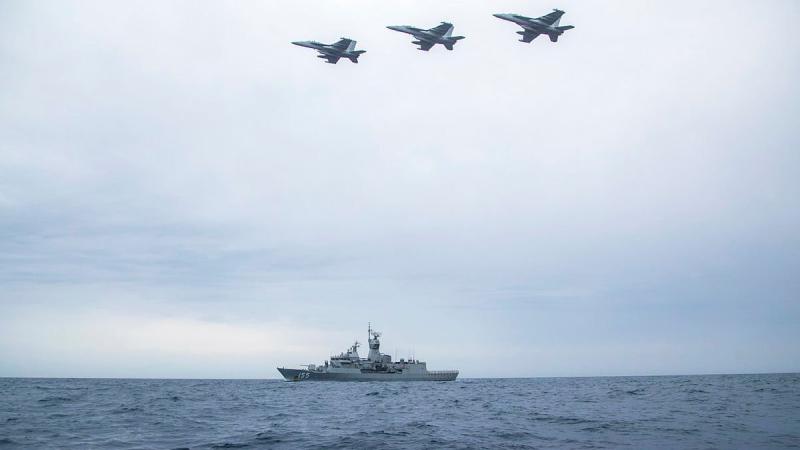 Three United States Navy EA-18G Growlers from VAQ-132 Squadron fly in formation over HMAS Ballarat. Photo: Leading Seaman Ernesto Sanchez