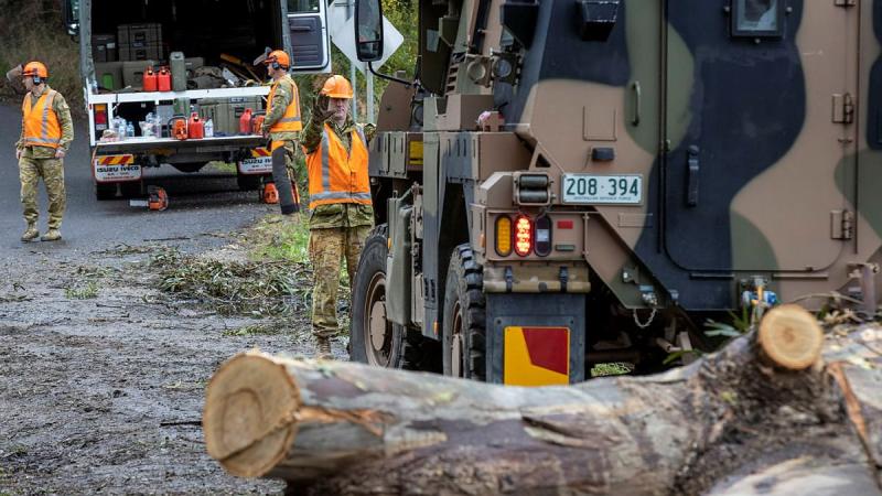 Members of the 22nd Engineer Regiment and the 4th/19th Prince of Wales Light Horse Regiment use a Bushmaster vehicle to drag a felled tree from a fire trail in Willung South, Victoria. Photo: Corporal David Cotton