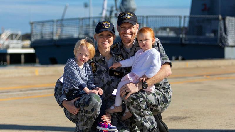 HMAS Anzac Flight Commander Lieutenant Commander Timothy Craig with wife Lieutenant Brittany Craig and children Hunter, left, and Harper at Oxley Wharf at Fleet Base West. Photo: Leading Seaman Ronnie Baltoft