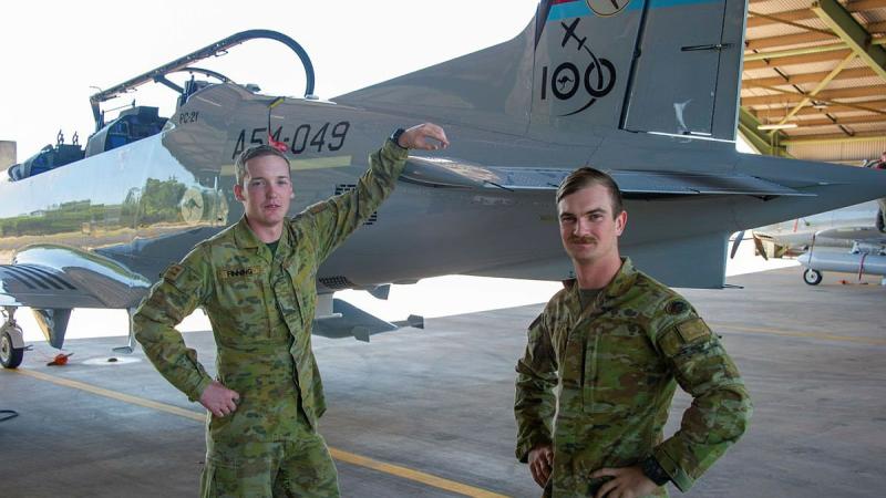 Gunners Liam Finner, left, and Jesse-Jon Thamm, of the 8th/12th Regiment, RAA, stand next to a Pilatus PC-21 from No. 4 Squadron during Exercise Thor's Run. Photo: Captain Carla Armenti