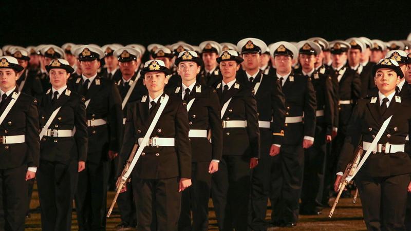 Graduates of the New Entry Officers Course 64 parade stand at attention during a ceremonial sunset on the evening before their graduation at HMAS Creswell, Jervis Bay. Photo: Able Seaman Leon Dafonte Fernandez 