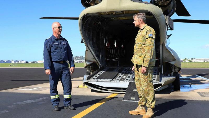 Former Army technician Greg Maiden, left, is congratulated by Commanding Officer 5th Aviation Regiment Lieutenant Colonel Christopher McDougall after completing 5000 flying hours in the CH-47. Photo: Private Emily Mann