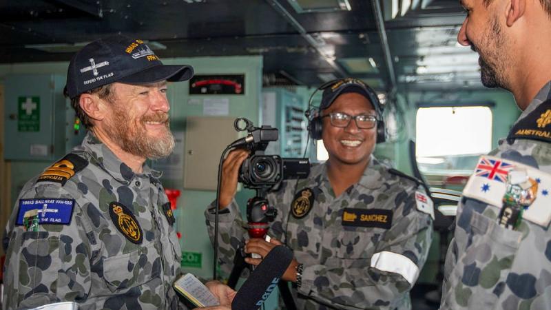 Lieutenant Gary McHugh and Leading Seaman Ernesto Sanchez interview Able Seaman Matthew Hicks on the ship's bridge during a Regional Presence Deployment. Photo: Leading Seaman Ernesto Sanchez