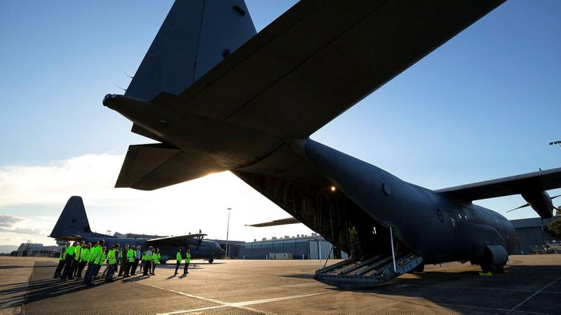 Quickstep Aerospace Services employees are given a tour of a No. 37 Squadron C-130J Hercules during a visit to RAAF Base Richmond. Photo: Corporal David Said
