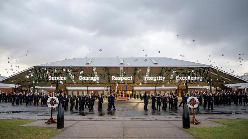 Graduating members of General Entry 389 Shipp Division throw their hats in the air at the end of their graduation parade at the Navy Recruit School at HMAS Cerberus, Victoria. Photo: Leading Seaman James McDougall