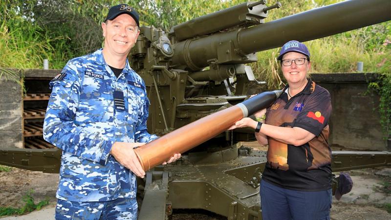 Commanding Officer No. 35 Squadron Wing Commander Scott Egan presents the curator of the Torres Strait Heritage Museum, Vanessa Seekee, with a replica 3.7-inch shell. Photo: Corporal Brett Sherriff