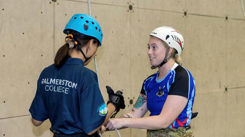 Signaller Catherine Welsh, right, from the 1st Combat Signal Regiment, with a young Indigenous woman from the Stars Foundation after an abseiling run at Robertson Barracks. Photo: Corporal Rodrigo Villablanca