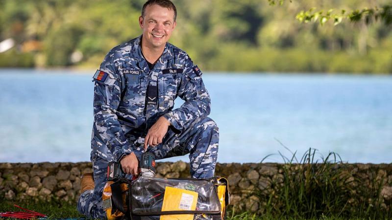 Leading Aircraftman Joseph Swain is on deployment alongside Australian Army personnel in Vanuatu installing off-grid solar panel systems to power radios in remote locations  Photo: Corporal Olivia Cameron
