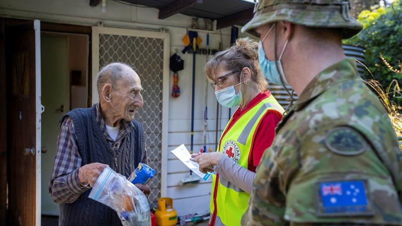 Mount Dandenong resident Jim Henderson has a welfare check by Australian Red Cross representative Kerry Macfarlane and Corporal Paul Summerbell after the recent storm. Photo: Corporal David Cotton