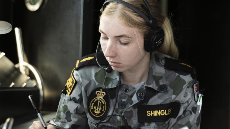 Able Seaman Communications and Information Systems Tamara Shingles communicates with ships in company, as HMAS Brisbane conducts replenishment at sea approach off the coast of Queensland, during Exercise Talisman Sabre 2021. Photo: LSIS Daniel Goodman