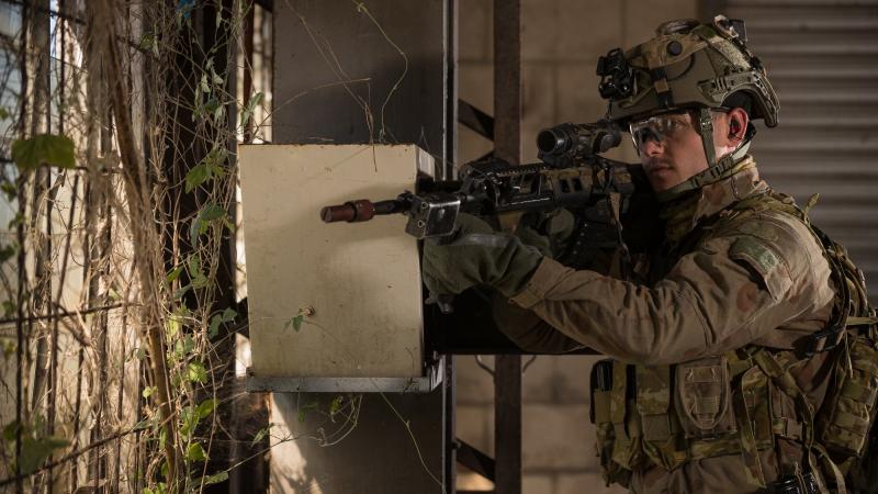Australian Army soldier Private Luke Armstrong from the 2nd Battalion, Royal Australian Regiment, provides window security during a role playing scenario held at Bowen in Queensland, during Exercise Talisman Sabre 2021. Photo: Corporal Madhur Chitnis