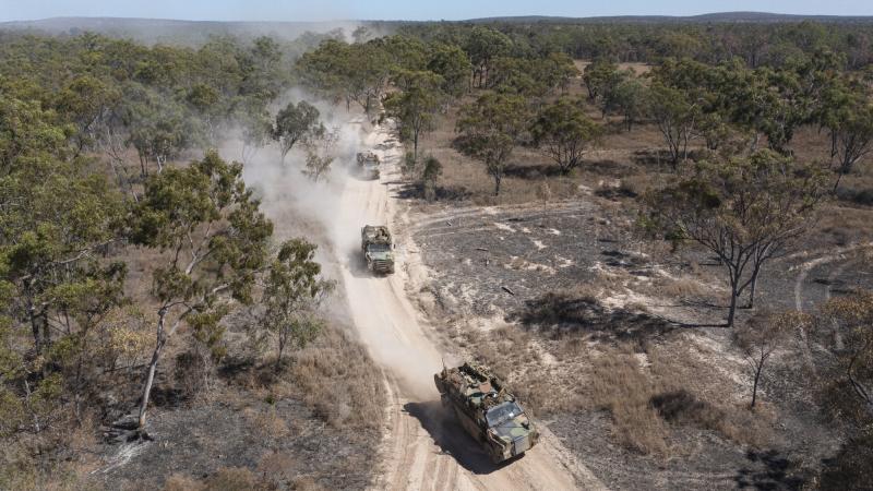 Australian Army Bushmaster's from Battlegroup Coral, conduct a forward passage of lines at the Townsville Field Training Area in Queensland, during Exercise Talisman Sabre 2021. Photo:  Corporal Brandon Grey