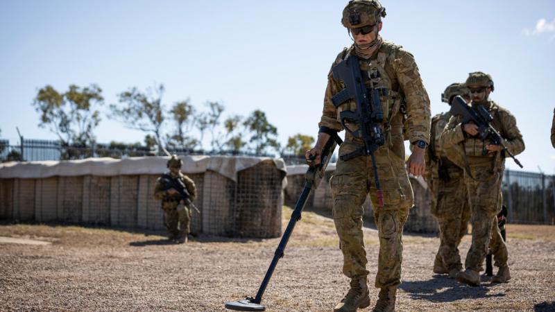 Australian Army soldiers from Battlegroup Eagle conduct a clearance of an enemy camp, at Townsville Field Training Area, Queensland, during Exercise Talisman Sabre 2021. Photo: Corporal Brandon Grey