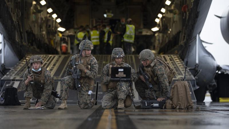United States Marines conduct a simulated wartime airfield scenario at the rear of a Royal Australian Air Force No. 36 Squadron C-17A Globemaster III aircraft at RAAF Base Amberley, QLD, during Exercise Talisman Sabre 2021. Photo: Corporal Jesse Kane