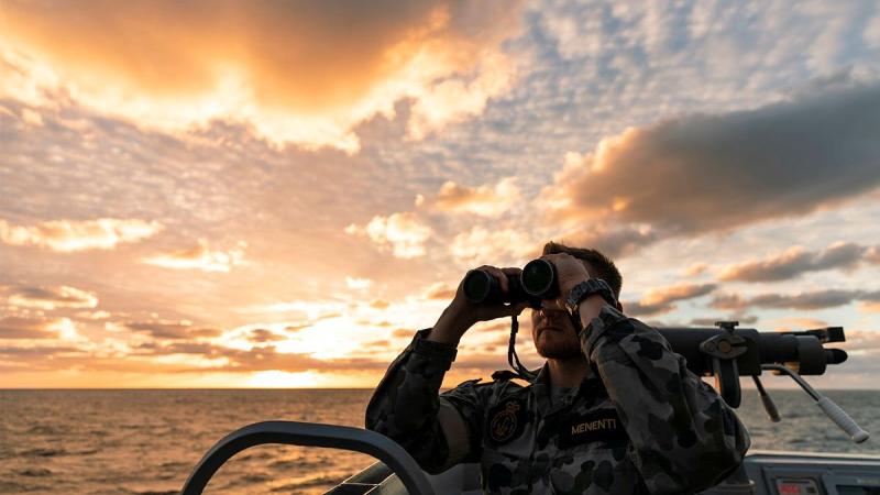 Officer of the watch Sub-Lieutenant Lucas Menenti looks out from HMAS Brisbane’s bridge wing during an air-warfare serial off the coast of Queensland on Exercise Talisman Sabre. Photo: Leading Seaman Daniel Goodman