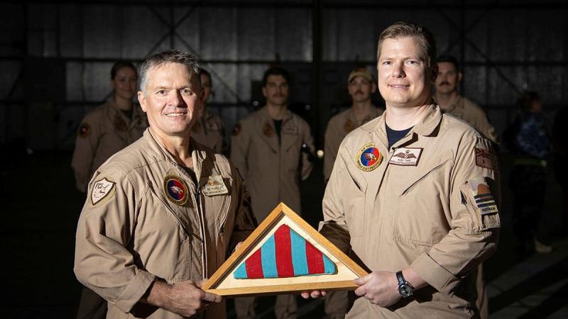 The Commander's Pennant for Air Task Group 630 is passed from outgoing commander Wing Commander Ric Peapell, left, to the incoming commander Wing Commander Alexander Cave. Photo: Glen McCarthy