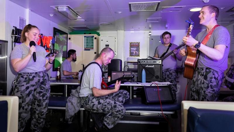 HMAS Brisbane’s band, made up of members of the crew, play their first gig together in front of a live audience in the junior sailors' café off the coast of Queensland during Exercise Talisman Sabre. Photo: Leading Seaman Daniel Goodman