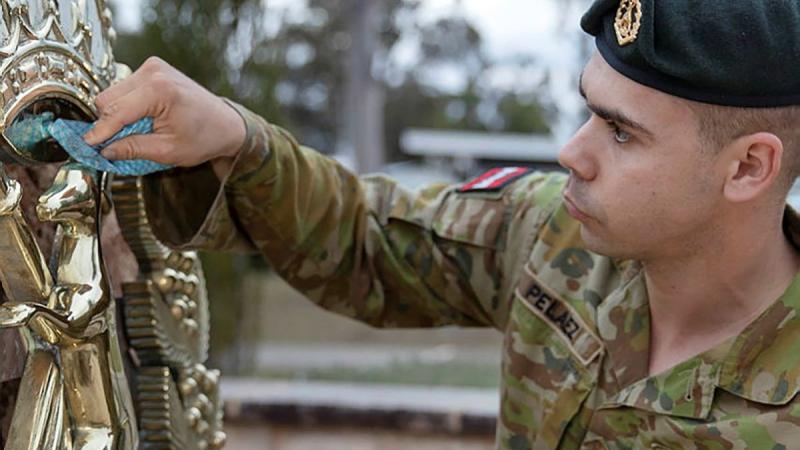 Corporal David-Jose Pelaez, a section commander from the School of Infantry, cleans the Skippy Badge at Depot Company headquarters, Singleton. Photo: Private Jacob Joseph 