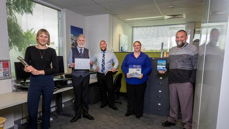 Naval History Section staff Honae Cuffe, Director John Perryman, Rob Garratt, Simone Alferink and Petar Djokovic celebrate the publication of their 400th ship history at their offices in Fyshwick, Canberra. Photo: Sergeant Sebastian Beurich