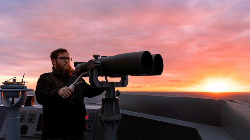 Able Seaman Boatswain’s Mate James Anson keeps watch from the bridge wing as HMAS Brisbane sails off the coast of Queensland during Exercise Talisman Sabre. Photo: Leading Seaman Daniel Goodman