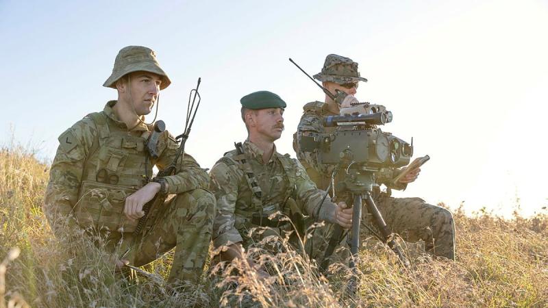 Lance Bombardier Matt Freegard, left, Royal Artillery Gunner Sam Rees and United States Marine Corps Captain Kurt James designate targets during an air strike on Exercise Talisman Sabre. Photo: Leading Aircraftwoman Jacqueline Forrester