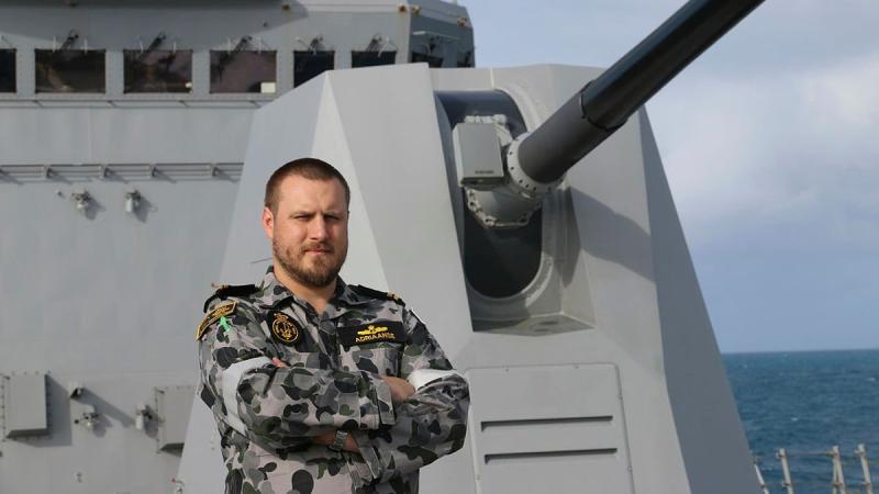 Weapons Electrical Engineering Officer Lieutenant Nick Adriaanse stands on the forecastle of HMAS Brisbane while sailing off the east coast of Queensland.