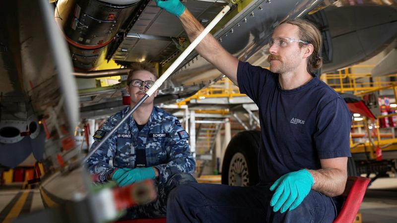 Aircraft fitter Aircraftman Blake Schober, from No.11 Squadron, left, and Airbus maintenance team member Daiman Gordon inspect the fuselage of a P-8A Poseidon at RAAF Base Edinburgh. Photo: Leading Aircraftman Sam Price