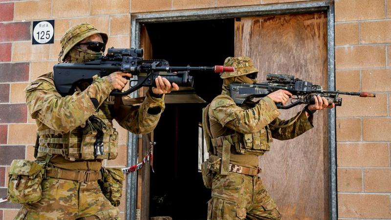 An Army soldier and Army Reserve soldier conduct urban close-combat clearances during an integration activity at Townsville Field Training Area during Exercise Talisman Sabre. Photo: Leading Aircraftwoman Emma Schwenke