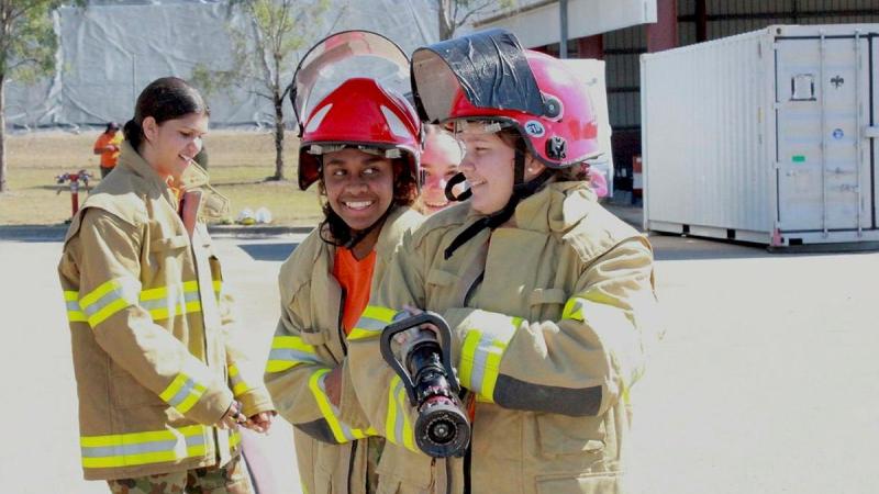 Khalia, Anne and Brieanna, from Stars Foundation, participate in a mock firefighting drill with 9 Petroleum Platoon, Lavarack Barracks as part of a Defence Work Experience Day. Photo: Corporal Ashely Hetherington 