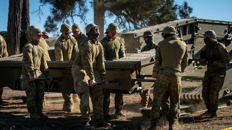 Soldiers from the 2nd Combat Engineer Regiment disassemble a medium girder bridge at Gayndah, Queensland. Photo: Private Jacob Hilton