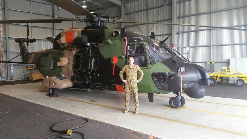 Army pilot Captain Charles Ford with an MRH90 Taipan in 2014.