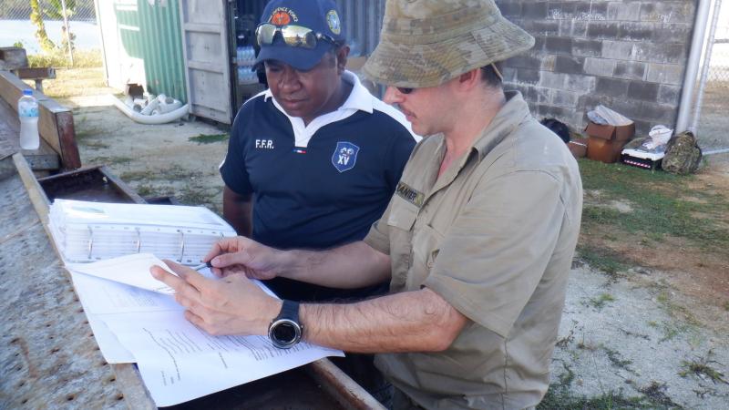 SIG Wayne Tranter provides a site brief to Papua New Guinea Navy Able Seaman Basil as part of the Communications Infrastructure Upgrade on Manus Island.