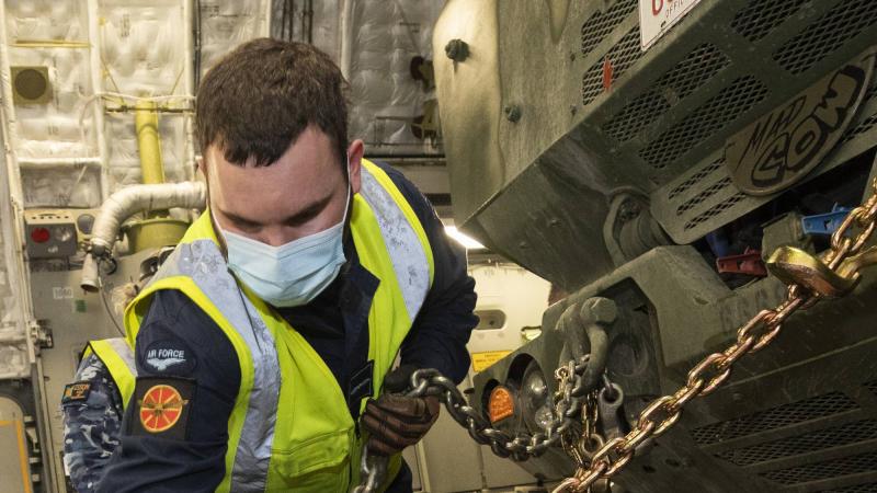 Royal New Zealand Air Force Leading Aircraftman Joshua Harris secures a US High Mobility Artillery Rocket System into a RAAF C-17A Globemaster III aircraft at RAAF Base Amberley. Photo: Corporal Jesse Kane