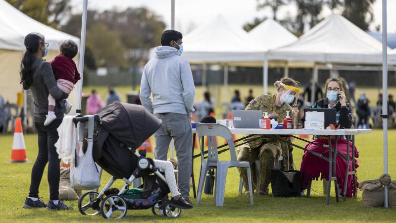 Private Claudia Gould assists NSW Health member Toni-Maree in helping members of the public in line for their Covid-19 vaccination at the Dubbo mass vaccination hub. Photo: Corporal Dustin Anderson 