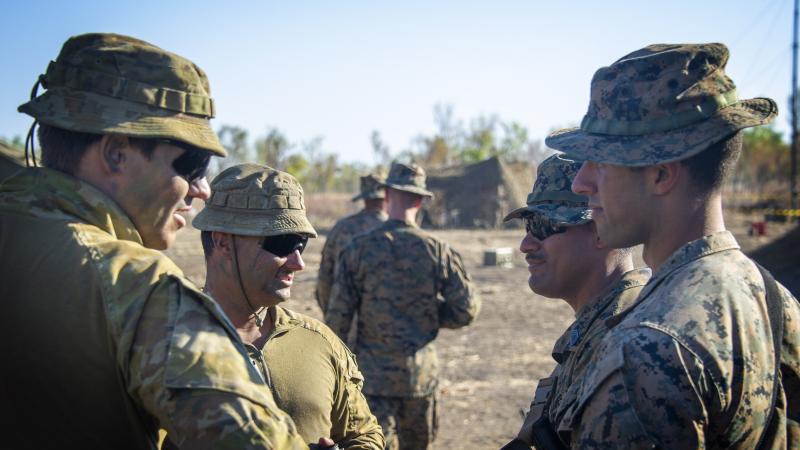 Australian soldiers from 1st Combat Signal Regiment discuss upcoming training with marines at Bradshaw Field Training Area during Exercise Koolendong. Photo: Captain Carla Armenti