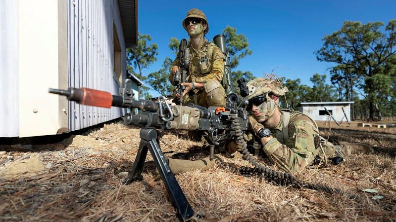 An Australian Army soldier from Battlegroup Coral and a US Army paratrooper provide security during clearance of an enemy position on Exercise Talisman Sabre at the Townsville Field Training Area. Photo: Corporal Brandon Grey