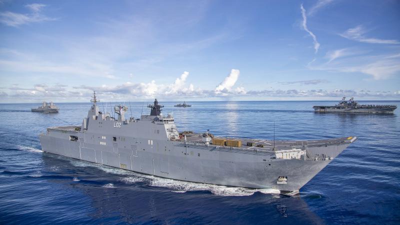 HMAS Canberra, front, conducts manoeuvres with USS New Orleans, left, JS Makinami and USS America during the Large Scale Global Exercise in the Western Pacific. Photo: Leading Seaman Ernesto Sanchez