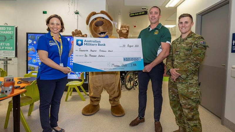 Soldiers from 3RAR donate a cheque for $10,000 to the children’s ward at Townsville University Hospital.  Photo: Corporal Brandon Grey