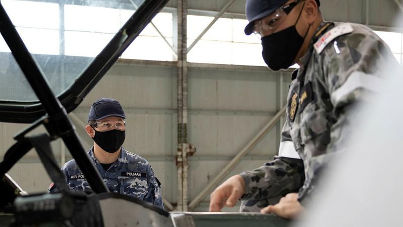 Trainee avionics technician Seaman Nattapol Popan, right, receives theory instruction from Royal Australian School of Technical Training Instructor Flight Lieutenant Chris Polman. 