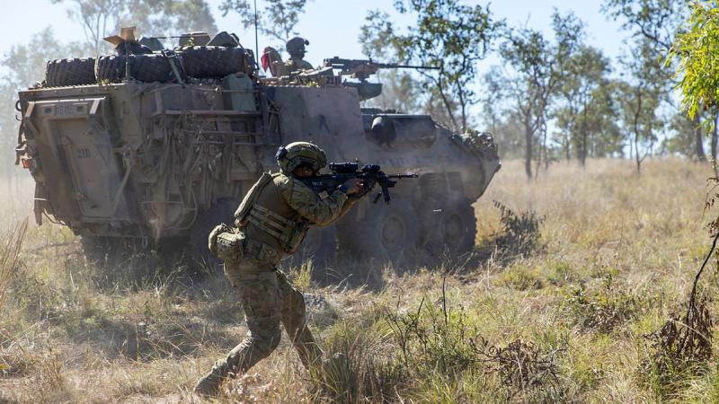 Private Harry Price from the 1st Battalion, Royal Australian Regiment, and mounted soldiers from the 2nd Cavalry Regiment engage an enemy position during Exercise Eagle Run at the Townsville Field Training Area. Photo: Corporal Brodie Cross
