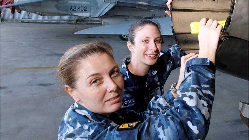 Wing Commander Shannan Forrest, left, in a file photo discussing the engineering characteristics of the F/A-18A Hornet engine exhausts. Photo: Sergeant Rob Mitchell