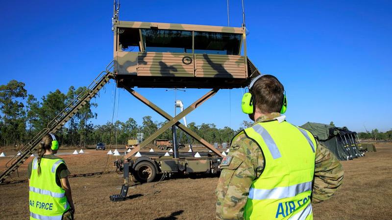 Leading Aircraftwoman Rebecca Hay and Corporal Thomas Geraghty raise the transportable air operations tower at RAAF Base Scherger. Photo: Corporal Brett Sherriff