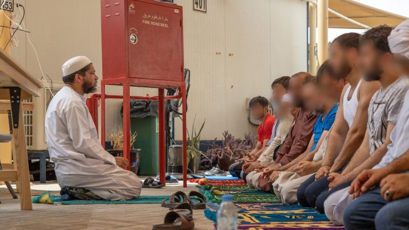 Islamic Imam, Royal Australian Navy Chaplain Majidih Essa, conducts Friday prayers for Muslim Afghanistan evacuees at the ADF's main operating base in the Middle East. Photo: Leading Aircraftwoman Jacqueline Forrester