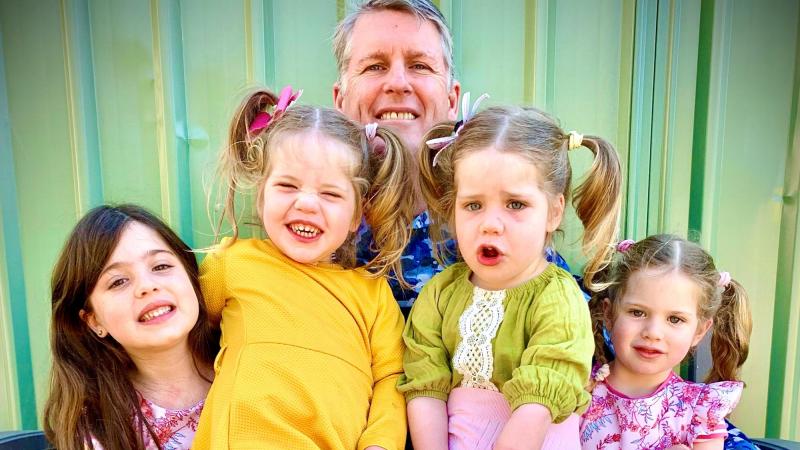 Flight Lieutenant Neil Young with his daughters, from left, Alexa, 6, twins Ella and Sophia, 2, and Ariana, 4.