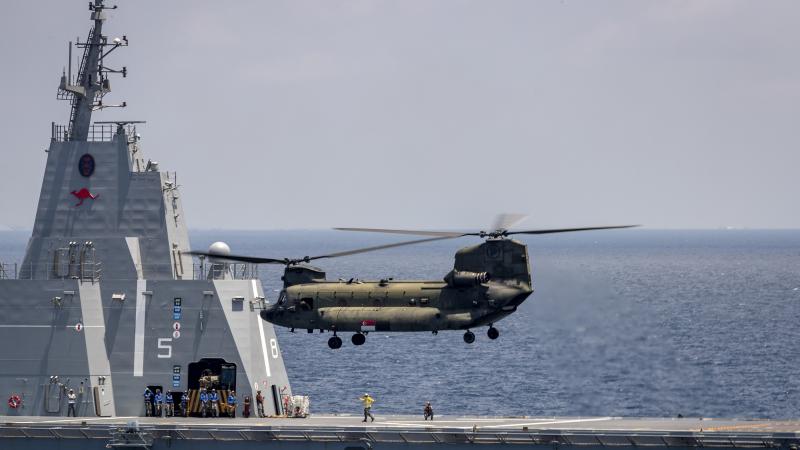 A Boeing CH-47 Chinook, from the Republic of Singapore Air Force, conducts training with HMAS Canberra during Indo-Pacific Endeavour 21. Photo: Leading Seaman Leo Baumgartner