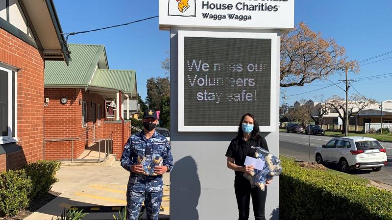 Aircraftman Antonio Keedle-Gradenza presents the donations to Lisa Simpson in Wagga Wagga.